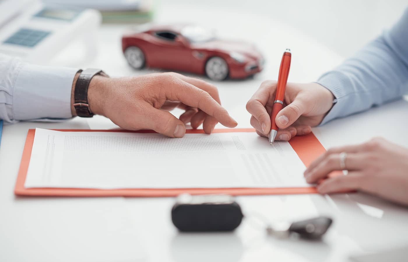 Driver signing a car insurance