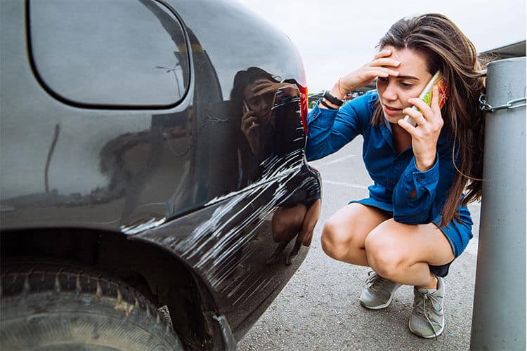 Woman on phone about car accident property damage claims