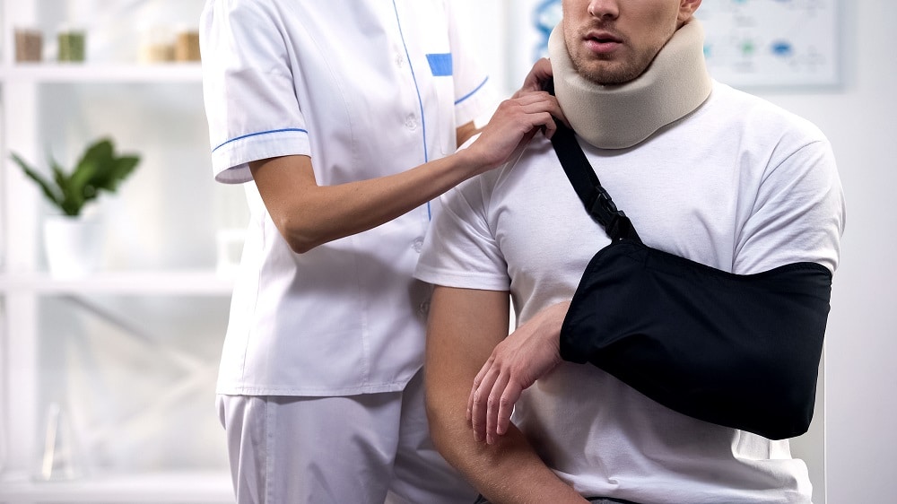 Man receiving medical care after a car accident