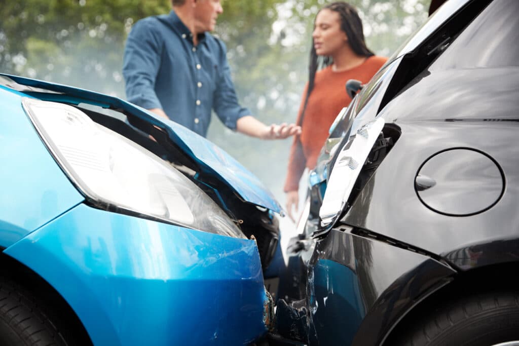 Rear end car accident with a man and woman talking - What to do after an accident in Texas