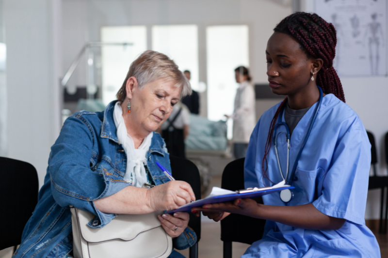 Woman signing medical documents at hospital. Prompt Medical Care. Pre-existing Conditions
