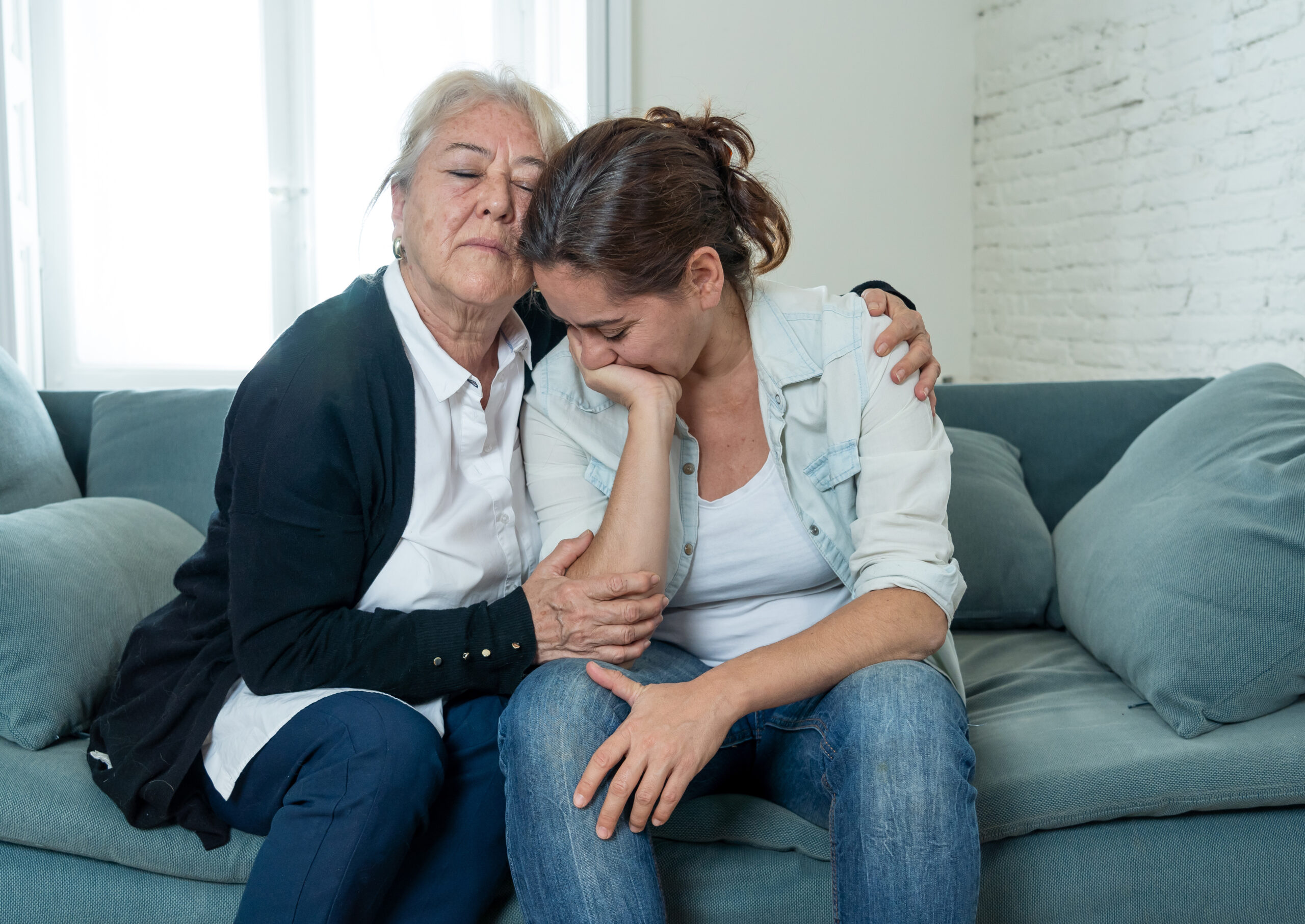 Senior mother comforting adult daughter grieving loss of loved one fighting the Coronavirus. Elderly mother embracing adult daughter suffering from depression. People affected by COVID-19 outbreak. Senior mother comforting adult daughter grieving loss of loved one fighting the Coronavirus. Elderly mother embracing adult daughter suffering from depression. People affected by COVID-19 outbreak. Senior mother comforting adult daughter grieving loss of loved one fighting the Coronavirus. Elderly mother embracing adult daughter suffering from depression. People affected by COVID-19 outbreak. abogados de Abusos en residencias de ancianos en san marcos
