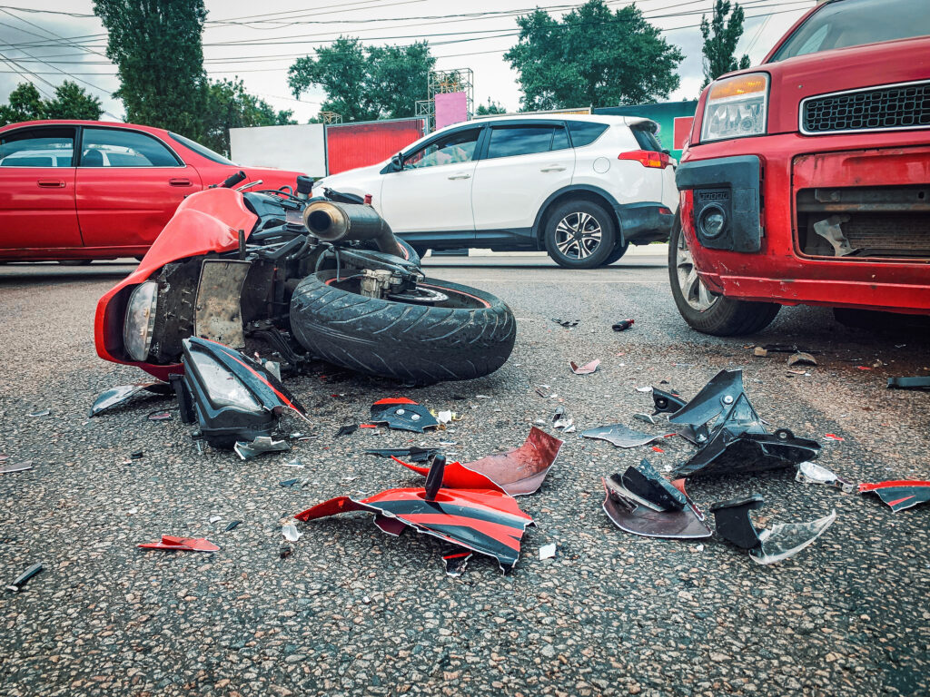 Motorcycle accident and car crash, broken and wrecked motor bike