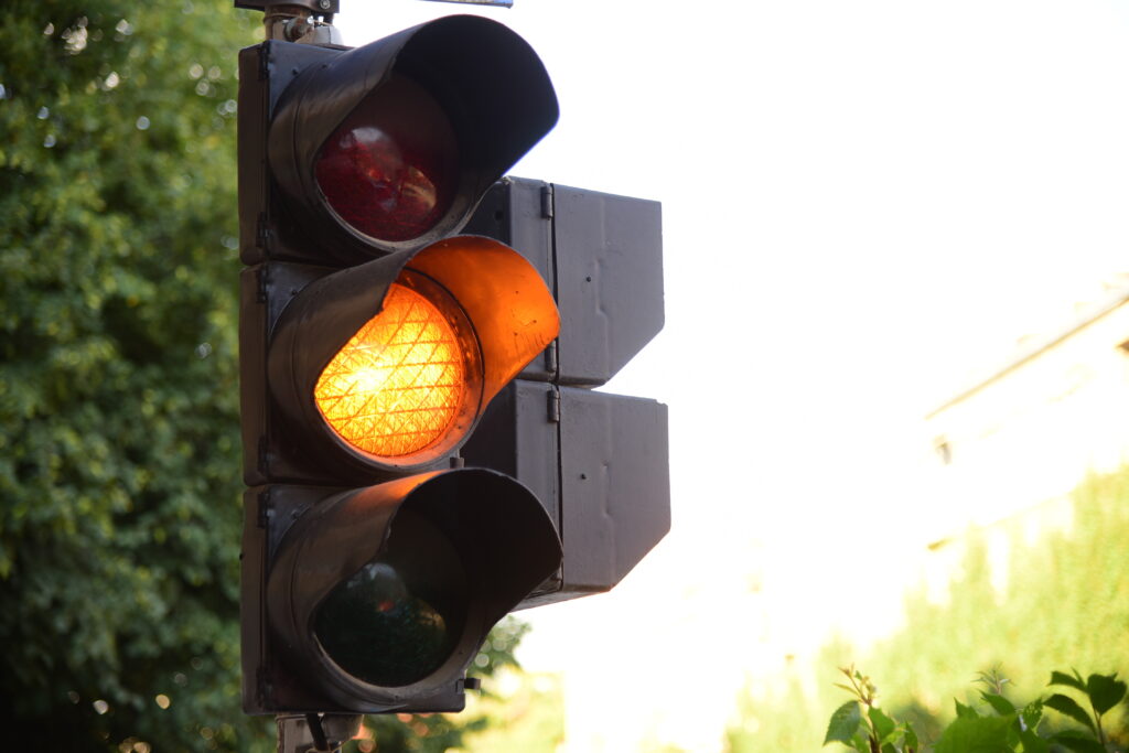 Yellow light of traffic lights in summer city - Is it Legal to Run a Yellow Light in Texas?