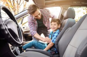 Niño sentado en el asiento delantero del carro - Edad que los niños pueden viajar en el asiento delantero por estado